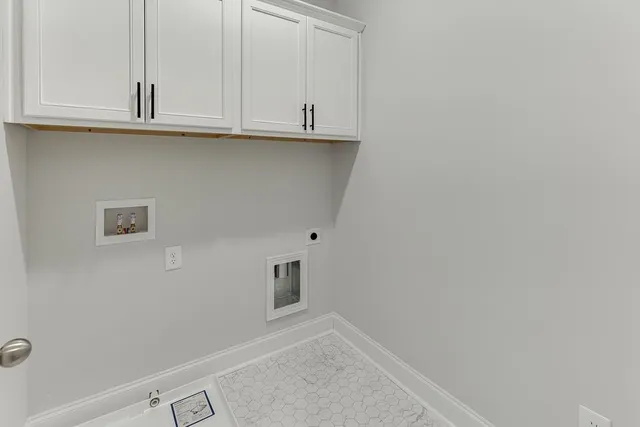 a living room with furniture a flat screen tv and a window