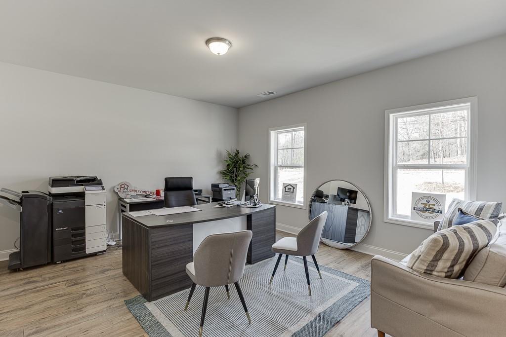 1276 Ainsworth Alley Sugar Hill, GA 30518 - Photo 33 of 56 a living room with furniture a flat screen tv and a window