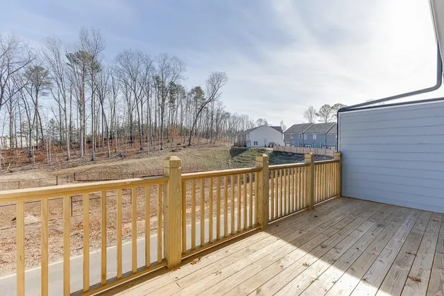 a view of balcony with wooden floor and fence