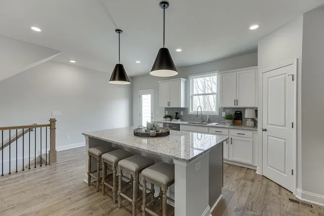 a kitchen with sink cabinets and wooden floor