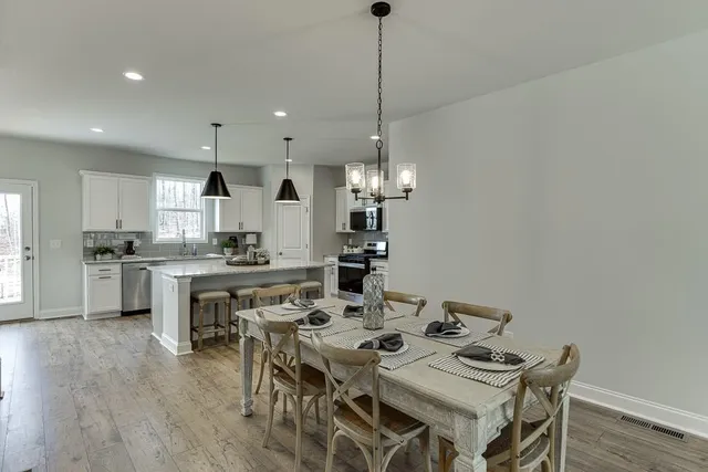 a large kitchen with a table and chairs