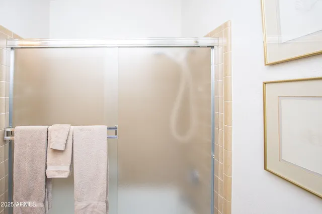 a bedroom with a large bed and a potted plant