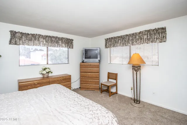 a bedroom with furniture and a wooden floor