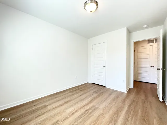 a view of a room with wooden floor