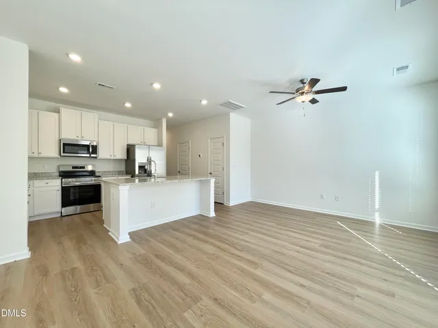 a view of kitchen with microwave and cabinets