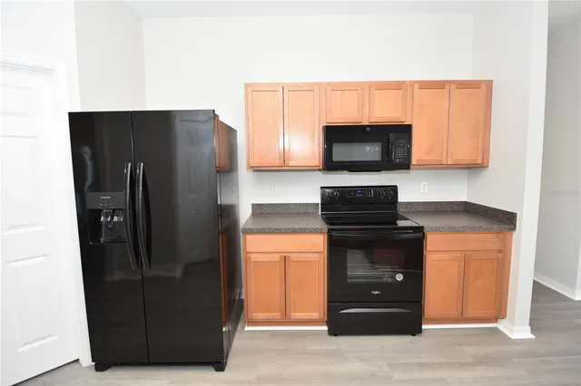 a kitchen with a refrigerator and a microwave