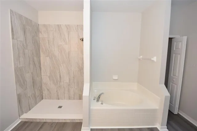a bathroom with a tub and shower