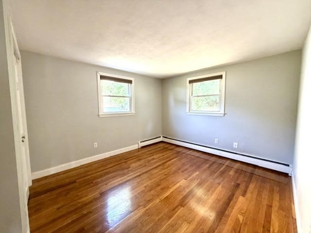 116 Upton Road Waltham, MA 02452 - Photo 14 of 22 a view of an empty room with wooden floor and a window