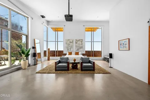 a spacious bedroom with a large bed and a large window