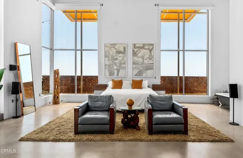 a living room with furniture and a floor to ceiling window