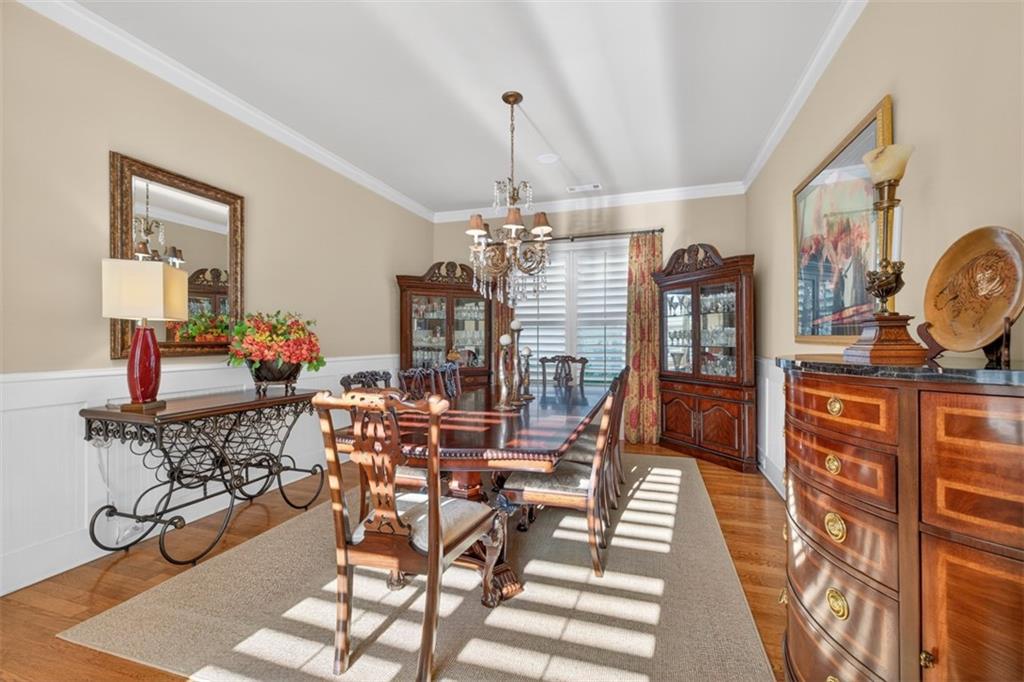 403 Tralee Court Statham, GA 30666 - Photo 11 of 98 a view of a dining room with furniture window and wooden floor
