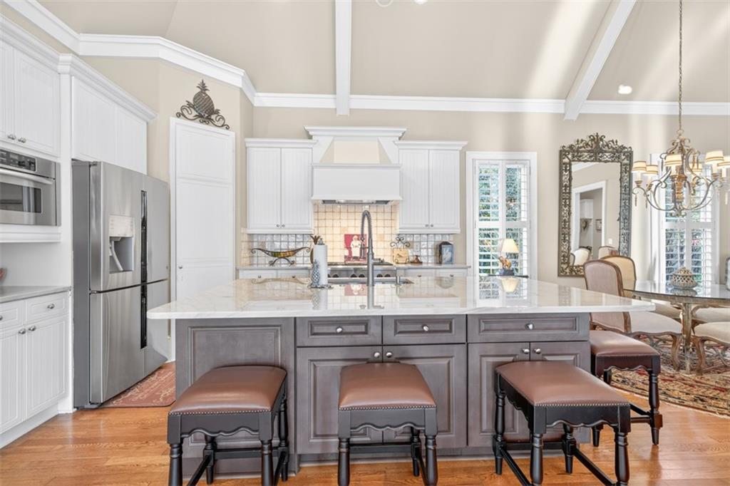 403 Tralee Court Statham, GA 30666 - Photo 23 of 98 a kitchen with stainless steel appliances a dining table chairs refrigerator and sink