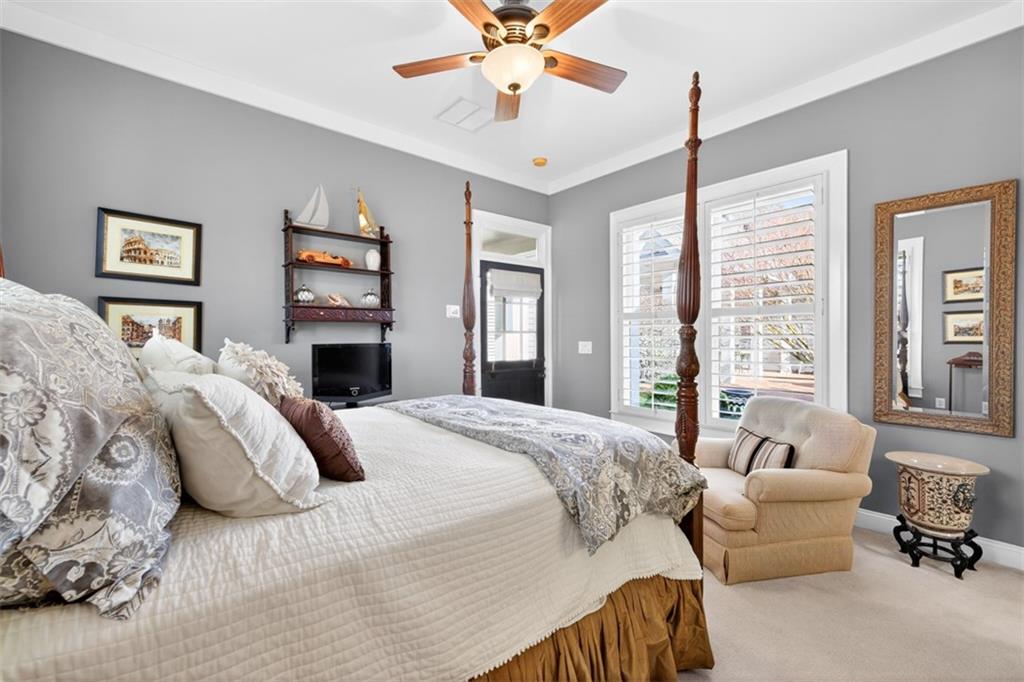 403 Tralee Court Statham, GA 30666 - Photo 71 of 98 a spacious bedroom with a bed and a chandelier