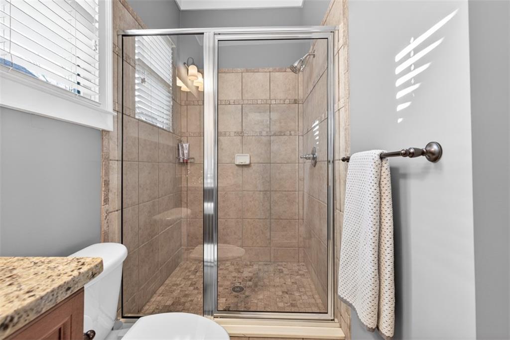 403 Tralee Court Statham, GA 30666 - Photo 73 of 98 a bathroom with a granite countertop shower a toilet and a sink