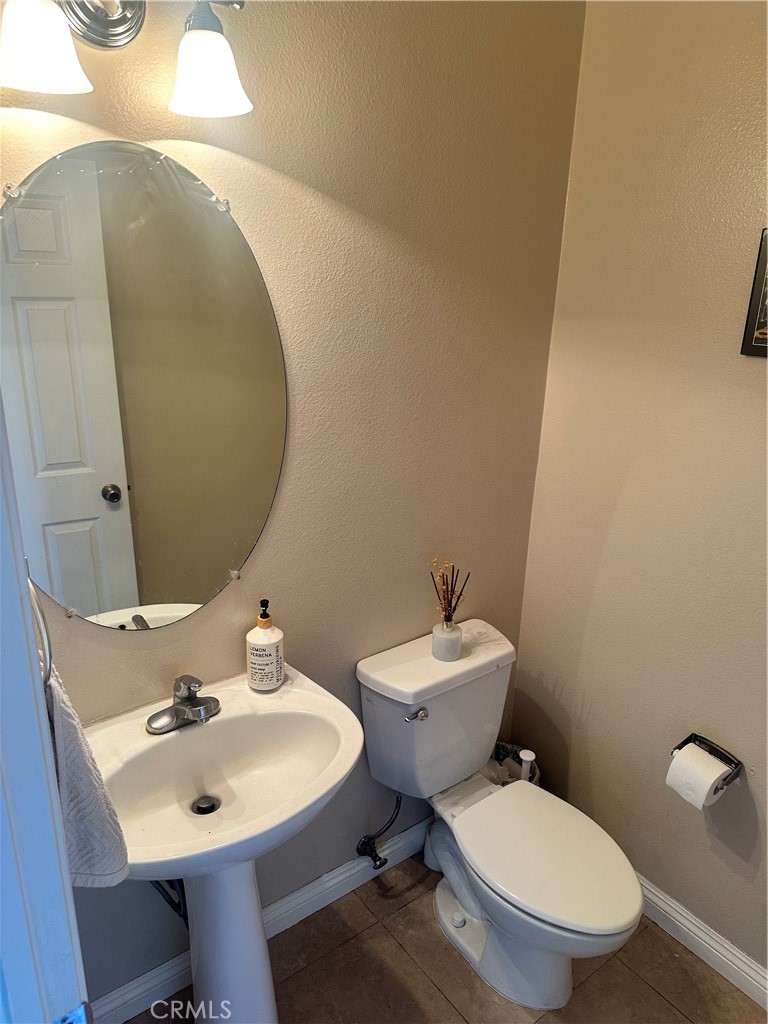 1646 Palermo Drive Riverside, CA 92507 - Photo 3 of 9 a bathroom with a toilet a sink and mirror