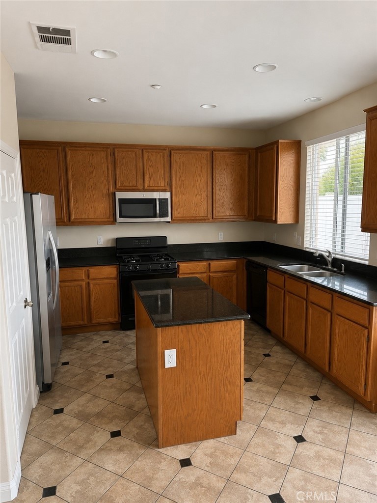 1646 Palermo Drive Riverside, CA 92507 - Photo 4 of 9 a kitchen with stainless steel appliances granite countertop a stove a sink and a refrigerator