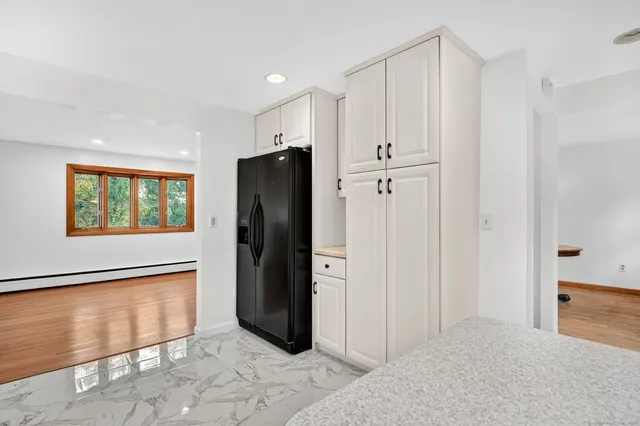 a view of an empty room with a kitchen