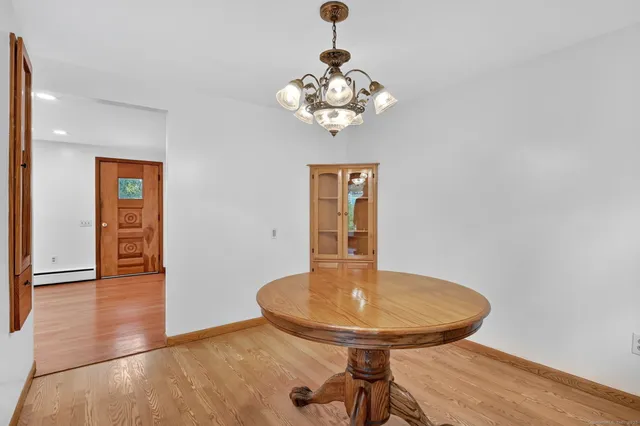 a view of a dining room with a table and chairs
