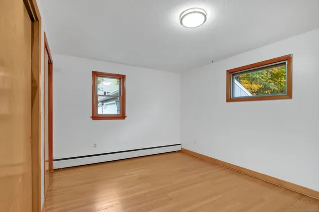 an empty room with a painting on the wall