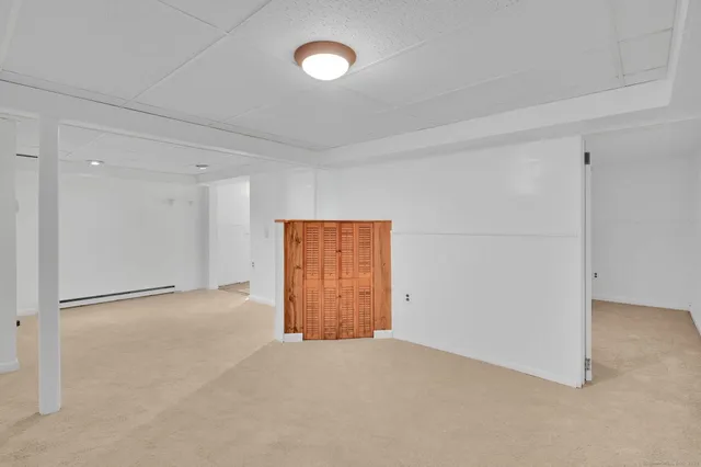 an empty room with windows and closet