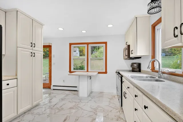 a kitchen with stainless steel appliances granite countertop a sink and a stove