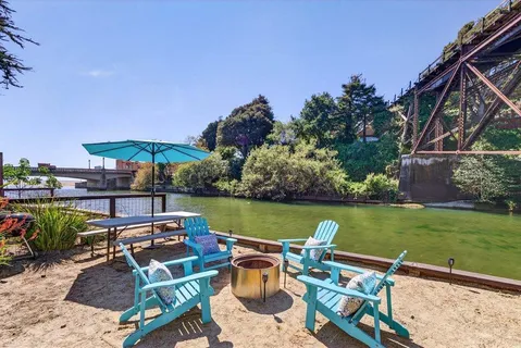 an outdoor sitting area with swimming pool and green space