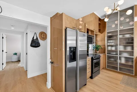 a kitchen with stainless steel appliances and refrigerator