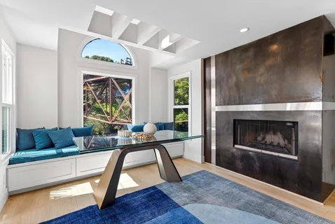 a view of a workspace with a table and chair in a room