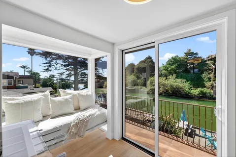 a living room with hardwood floor and a large window