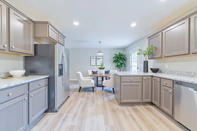 a kitchen with white cabinets and sink