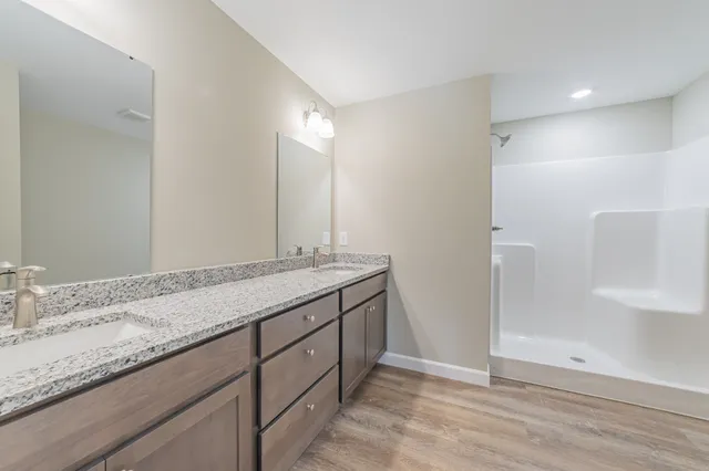 a bathroom with a granite countertop sink and a mirror