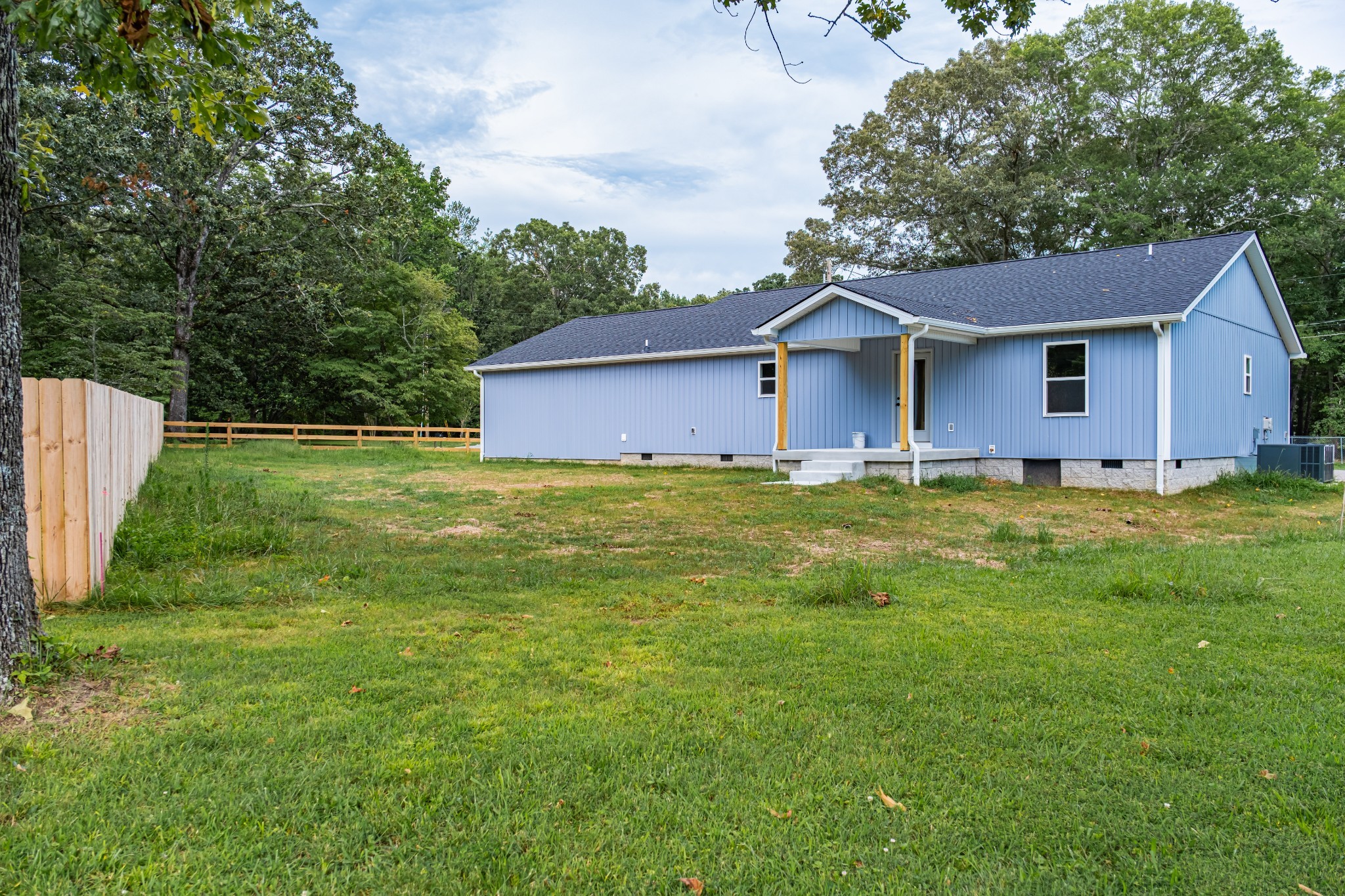 341 Wiseman Road Tullahoma, TN 37388 - Photo 20 of 21 a house that is sitting in the grass with large trees and plants