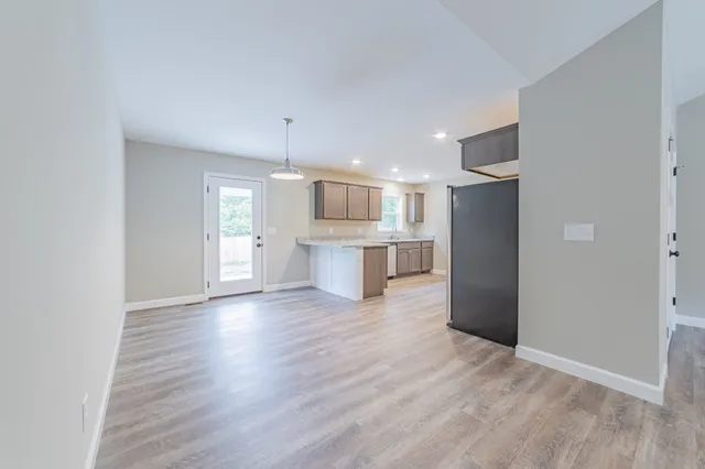 a view of a kitchen with a sink and a refrigerator