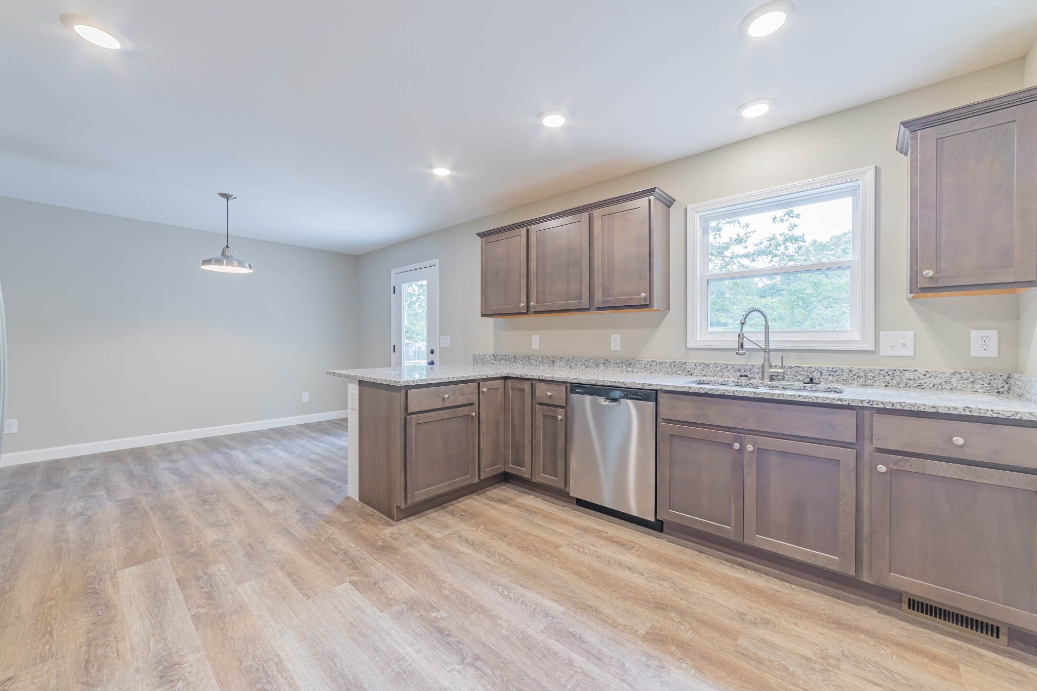 341 Wiseman Road Tullahoma, TN 37388 - Photo 7 of 21 a kitchen with granite countertop a sink window and cabinets