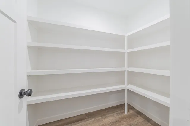 a view of walk in closet with empty racks