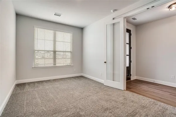 an empty room with windows and closet