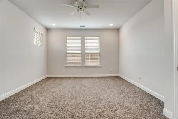 an empty room with a empty space and windows