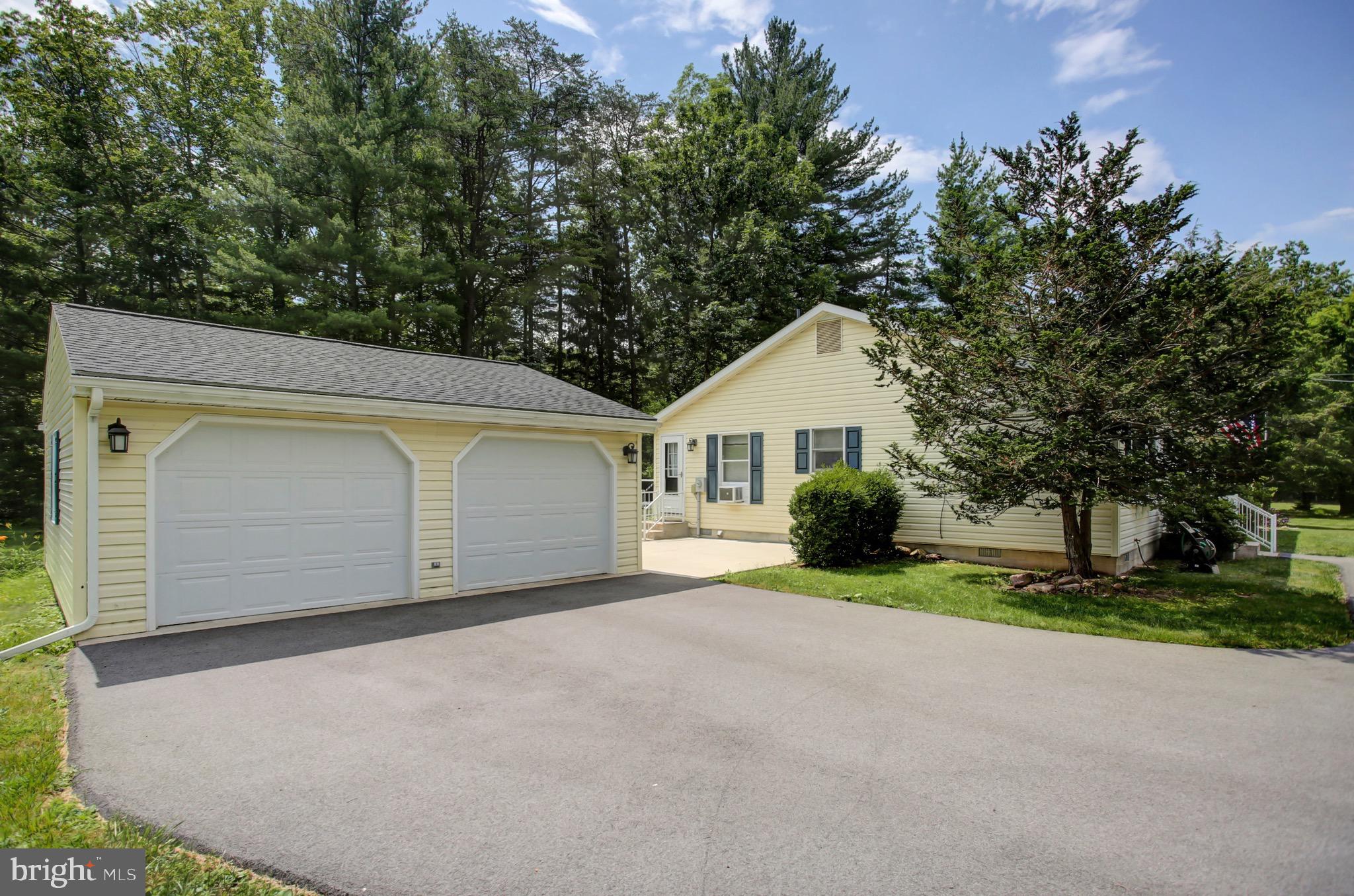 21796 Amberson Road Spring Run, PA 17262 - Photo 2 of 39 a front view of a house with a yard and garage