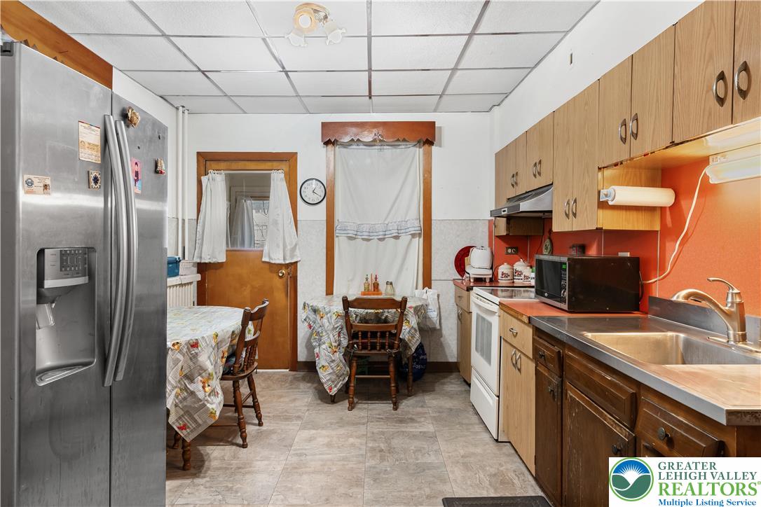 535 North Front Street Allentown, PA 18102 - Photo 32 of 51 a kitchen that has a lot of cabinets a sink and a refrigerator