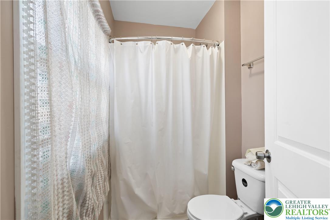 535 North Front Street Allentown, PA 18102 - Photo 35 of 51 a bathroom with a toilet and shower curtain