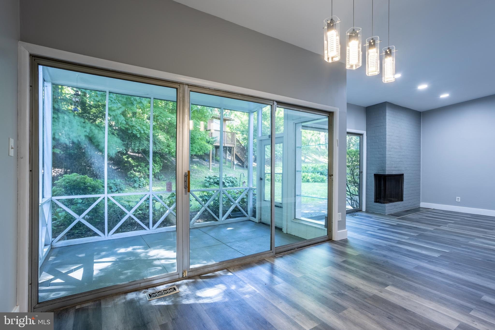 3207 Midfield Road Pikesville, MD 21208 - Photo 11 of 45 a view of a livingroom with a chandelier wooden floor and windows