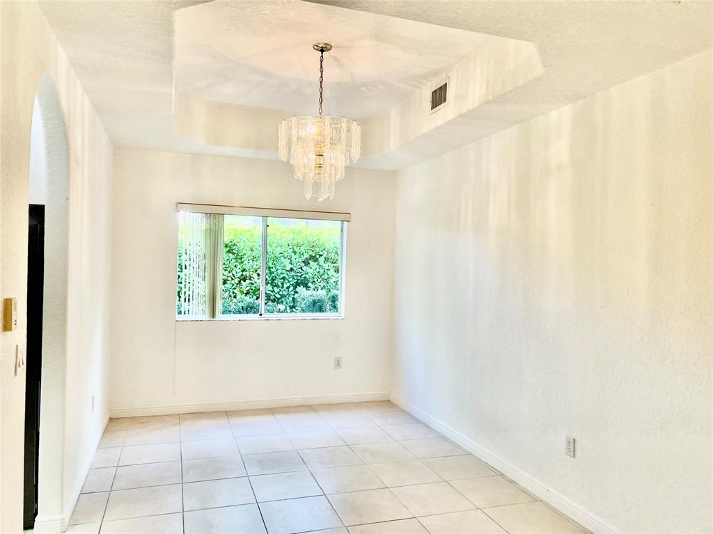 7932 Exeter Circle West, Unit 7932 Tamarac, FL 33321 - Photo 11 of 18 a view of an empty room with a window