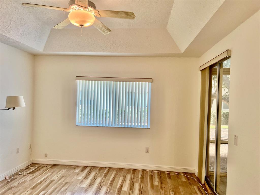 7932 Exeter Circle West, Unit 7932 Tamarac, FL 33321 - Photo 12 of 18 a view of a room with wooden floor and windows