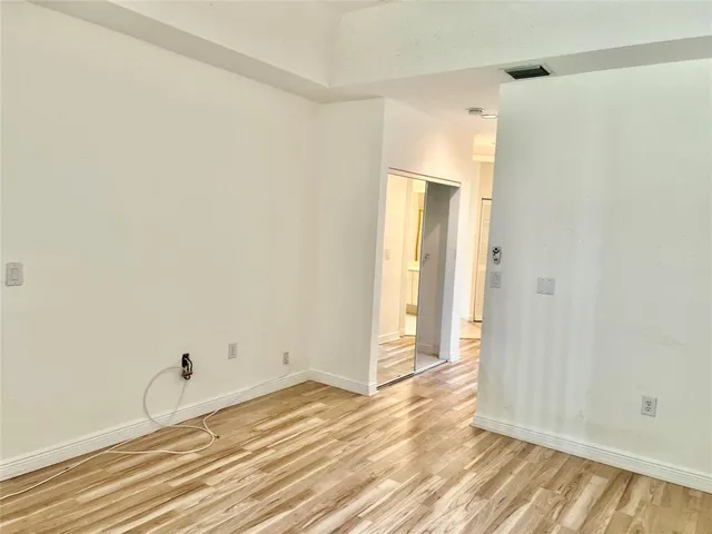 a view of a room with wooden floor and closet