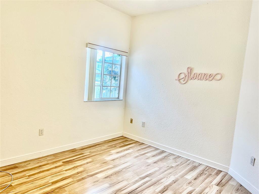 7932 Exeter Circle West, Unit 7932 Tamarac, FL 33321 - Photo 14 of 18 a view of a room with wooden floor and closet