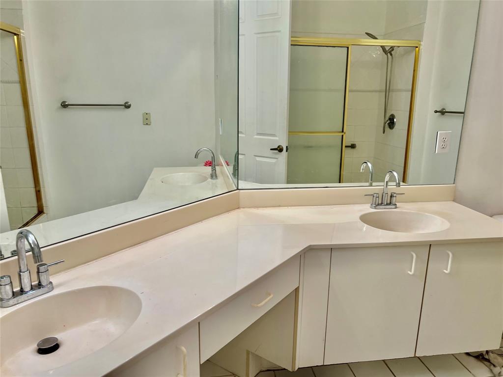 7932 Exeter Circle West, Unit 7932 Tamarac, FL 33321 - Photo 15 of 18 a bathroom with a sink and a mirror