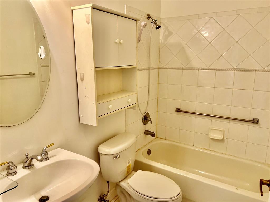 7932 Exeter Circle West, Unit 7932 Tamarac, FL 33321 - Photo 16 of 18 a bathroom with a sink toilet and shower