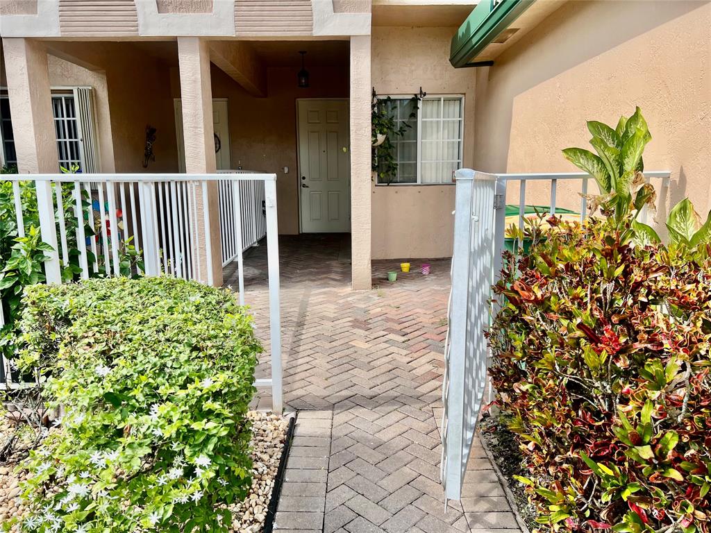 7932 Exeter Circle West, Unit 7932 Tamarac, FL 33321 - Photo 2 of 18 a view of a house with a flower garden