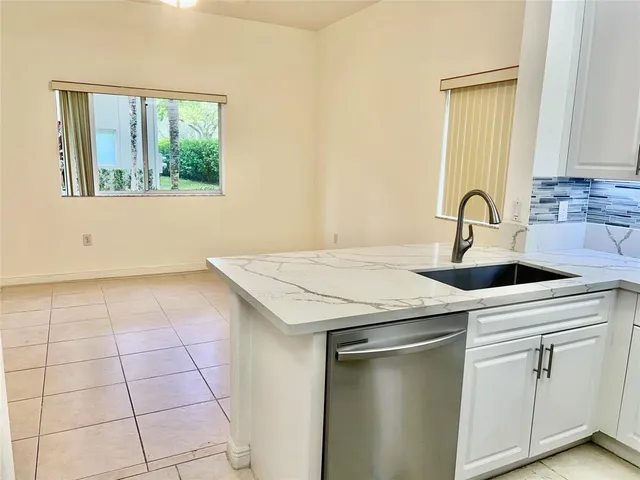 a kitchen with a sink a stove and cabinets
