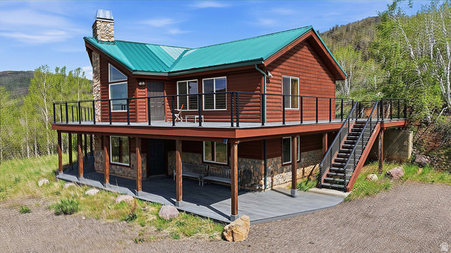 6 Beaver Springs Rancheros Oakley, UT 84055 - Photo 46 of 68 Mountain-style exterior featuring log siding and a vibrant green metal roof